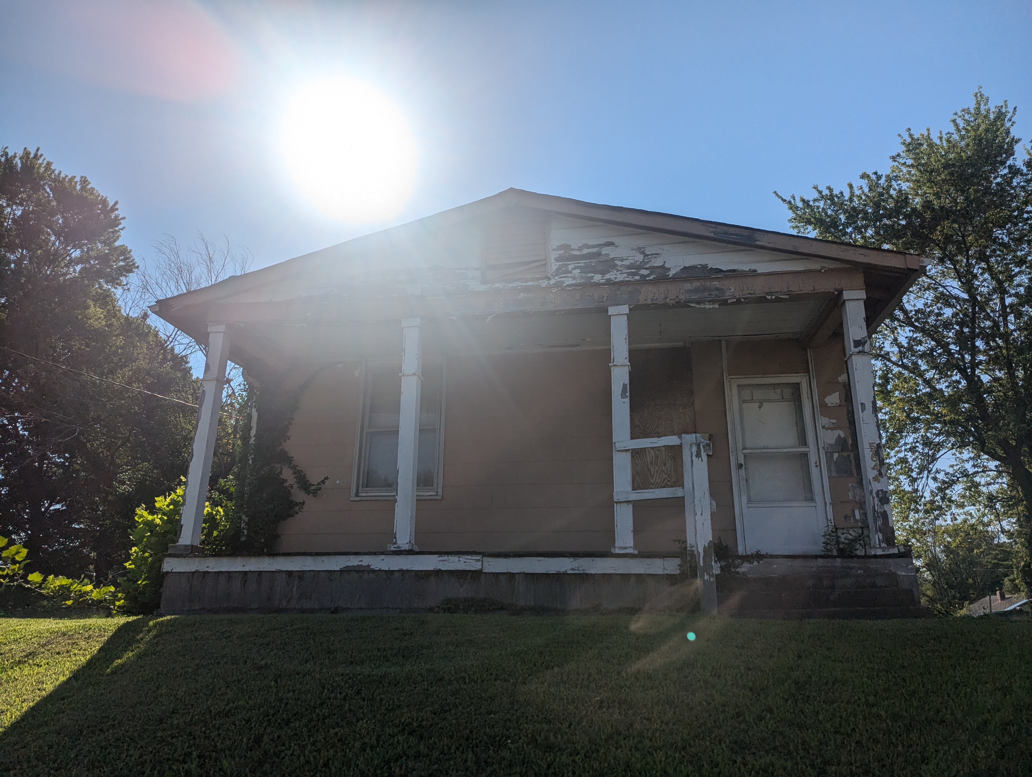 Front exterior of an older St. Louis home showing visible wear.